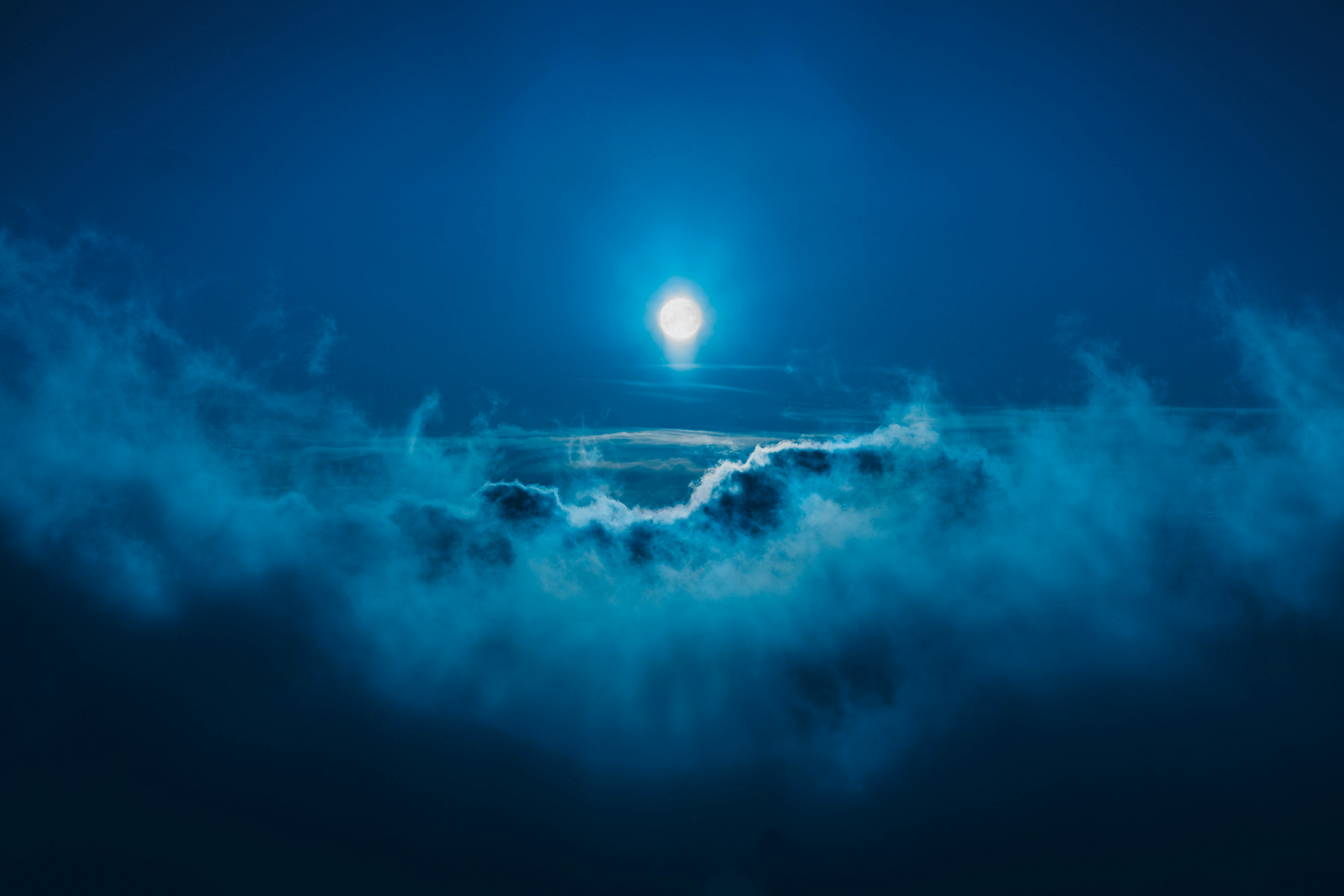 full moon along clouds